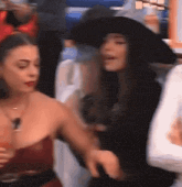 a woman in a witch costume is dancing with another woman .