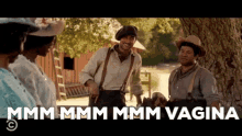 a group of men standing under a tree with the words mmmm mmmm mmmm vagina written above them