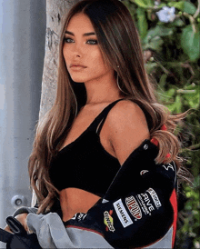 a woman wearing a jacket that says nascar on the sleeves