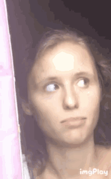 a close up of a woman 's face with her eyes closed .