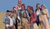 a group of people dressed in traditional costumes are standing together