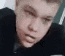 a close up of a man 's face with a blurred background .