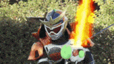 a man in a samurai costume is holding a green tennis ball and a fire sword .