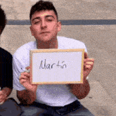 a man is holding a sign that says martin