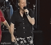 a man singing into a microphone with the website imgflip.com visible in the corner
