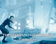 a woman in a black suit is jumping in the air with the words " this was in the trailer though "