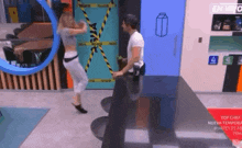 a man and woman are dancing in a room with a milk carton on the door