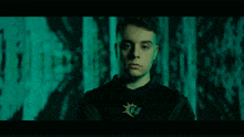 a young man wearing a black hoodie with the letter g on it