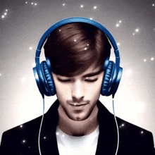 a man wearing headphones with his eyes closed looks down