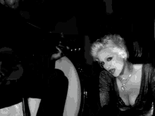 a black and white photo of a person holding a candle