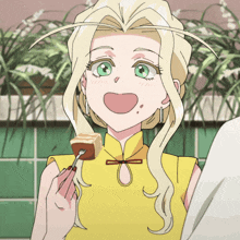 a girl with blonde hair and green eyes is holding a piece of food in her hand