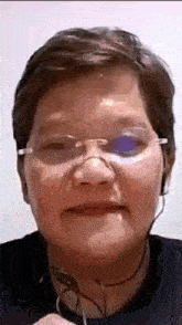 a woman wearing glasses and headphones is making a funny face