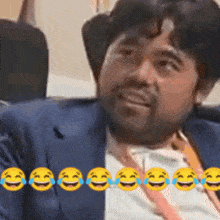 a man in a suit and tie is surrounded by laughing emojis