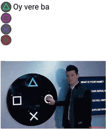 a man pressing a button next to a playstation controller