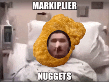 a picture of a man in a hospital bed with a chicken nugget in front of him that says markiplier nuggets