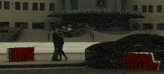 a couple standing in front of a federal bureau of investigation