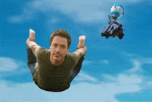 a man is flying through the air with a parachute in the background