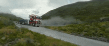 a red truck is driving down a road with smoke coming out of the back