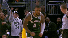 a basketball player wearing a milwaukee jersey