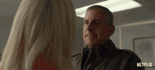 a man and a woman are looking at each other with a netflix logo on the bottom