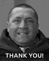 a man is smiling in a black and white photo with the words `` thank you '' .