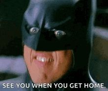 a close up of a person wearing a batman mask saying see you when you get home .