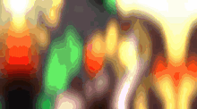 a blurred image of a christmas tree with a green and orange glow