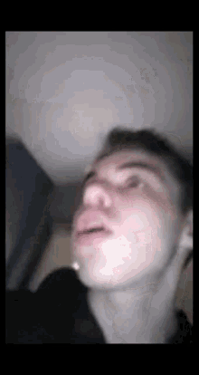 a close up of a man 's face with his eyes closed and his mouth open .