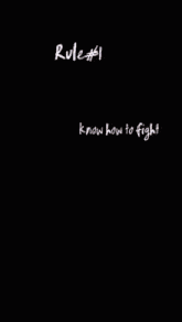 a person is kneeling down in front of a punching bag that says rule # 1 know how to fight on it