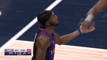 a basketball player wearing a number 5 jersey is running on the court