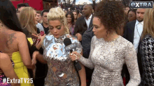 a woman is being interviewed by a reporter for extra