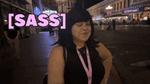 a woman wearing a lanyard with the word sass written on it