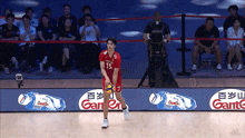 a volleyball player in a red jersey with the number 15 on it