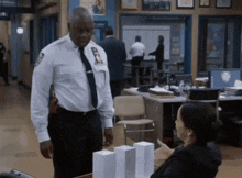 a man in a uniform with a badge that says nypd stands next to a woman