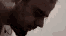 a close up of a man 's face with blood coming out of his nose and mouth .
