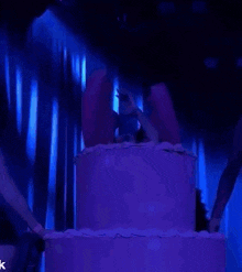 a woman is singing into a microphone on a stage