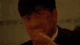 a man in a suit and tie is eating something with a fork .