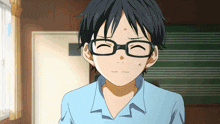 a boy wearing glasses and a blue shirt is looking at something