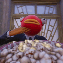 a man in a suit and tie with a red fish head covering his face