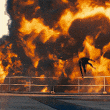 a person is jumping in front of a large explosion that says kepler on the bottom
