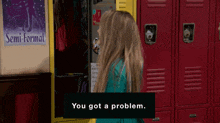 a girl stands in front of a locker with a semi-formal poster on the wall