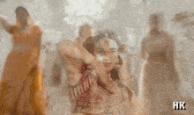 a blurred image of a woman with hk written on the bottom right