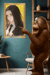 a monkey is pointing at a picture of a woman