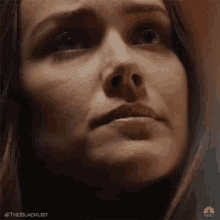 a close up of a woman 's face with her eyes closed and her mouth open .