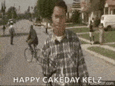 a man in a plaid shirt is walking down a street with a bicycle .
