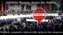 a large group of people are gathered in front of a sign that says arbeiter bauern fester die waffen