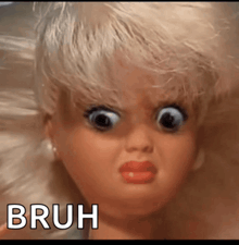 a close up of a doll 's face with the words bruh written below it