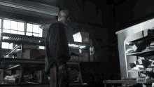 a man stands in a dark room with a sign that says a & mc