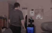 a blurry picture of a man standing in a room with a sign that says ' exit ' on it