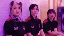 three girls wearing shirts with the numbers 0001 and 0011